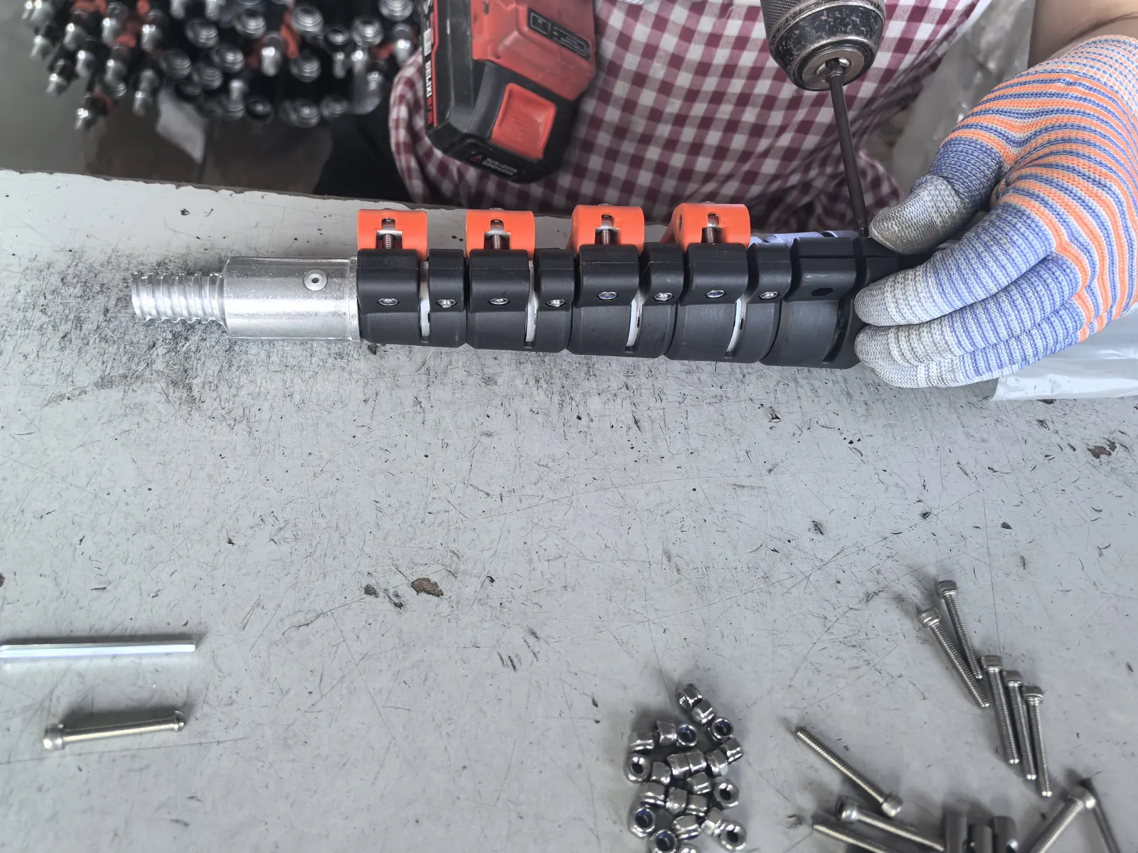 Worker fitting clamps and connectors to a telescopic pole