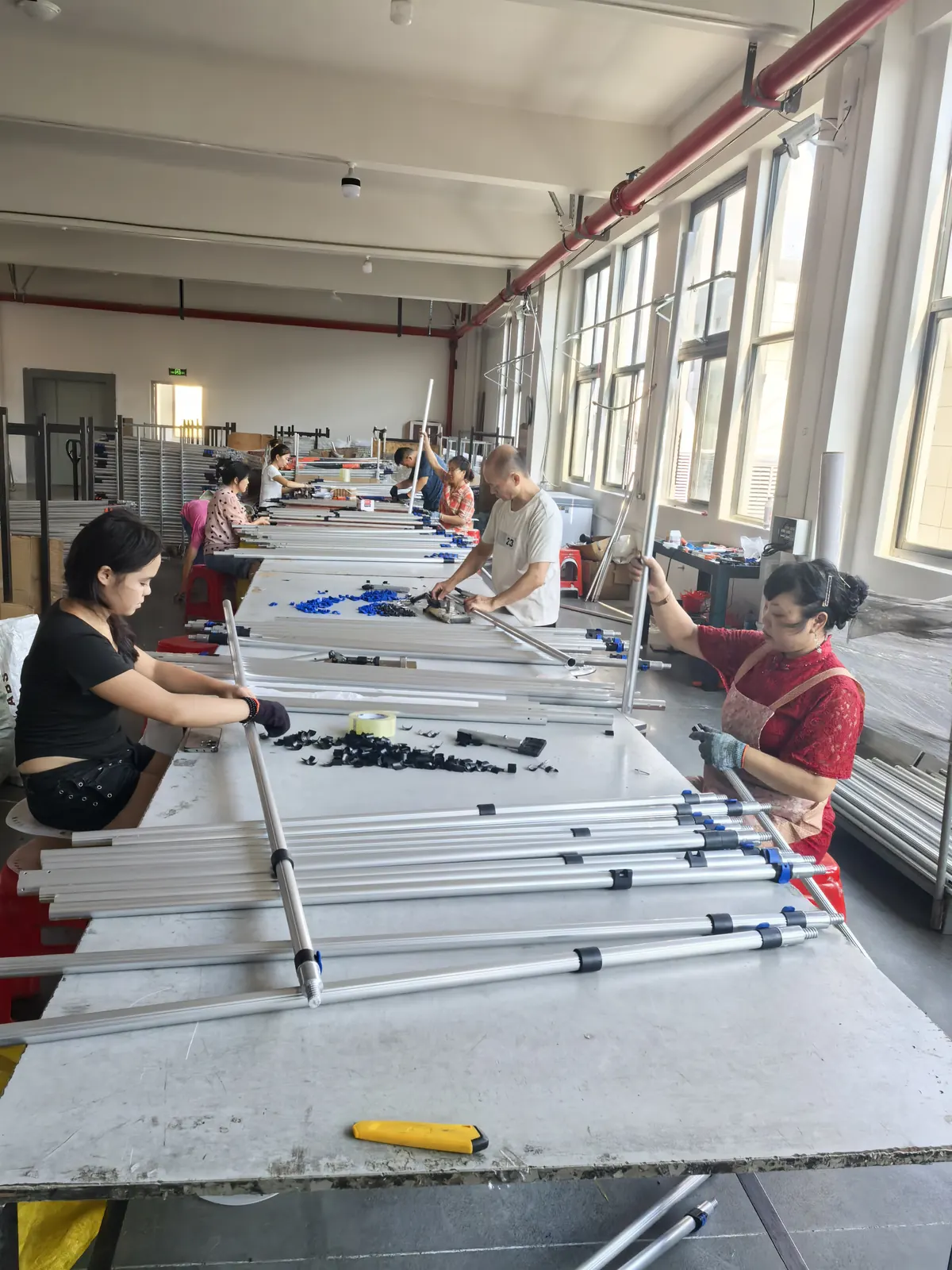 Workers assembling telescopic poles inside the CleanSystem Pro factory